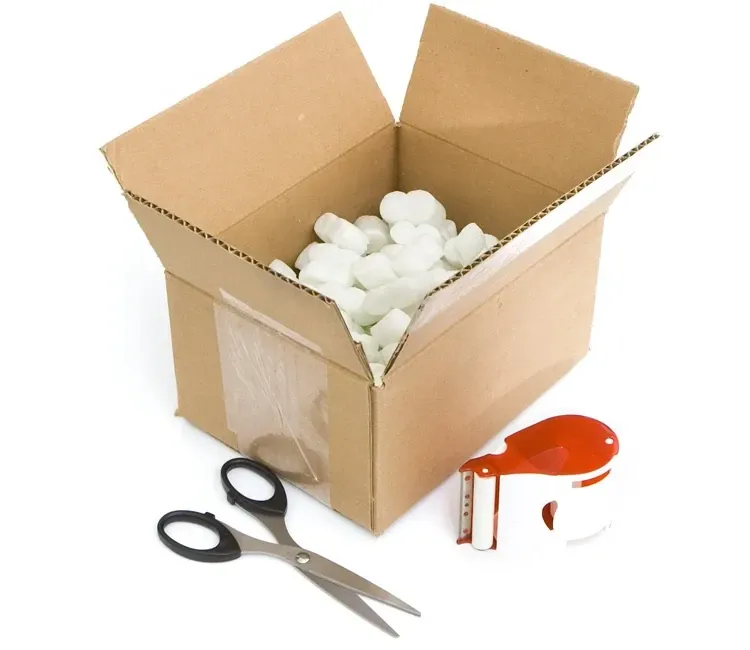 Open box and scissors and packing tape laid out